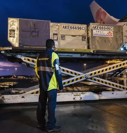 Mainfreight employee watching a load onto an airplane