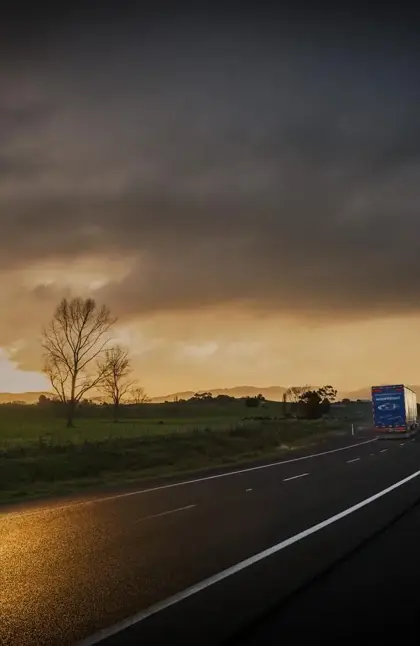 Mainfreight truck on road at sunrise