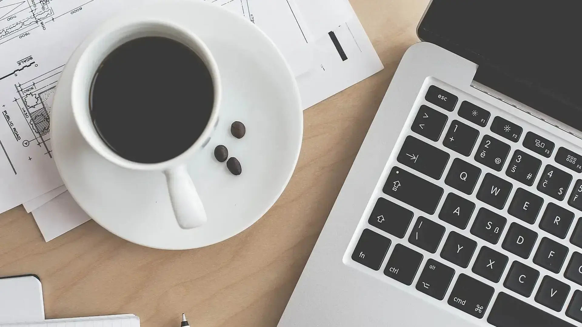 Coffee and laptop on desk