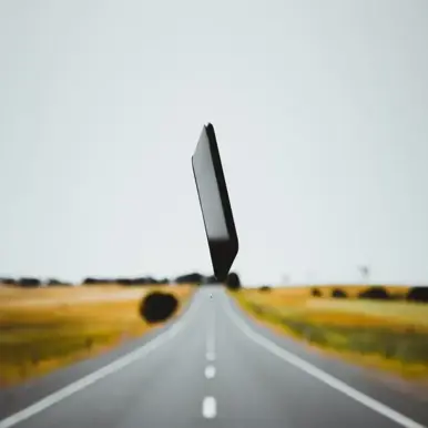 Mobile phone in middle of road in the air