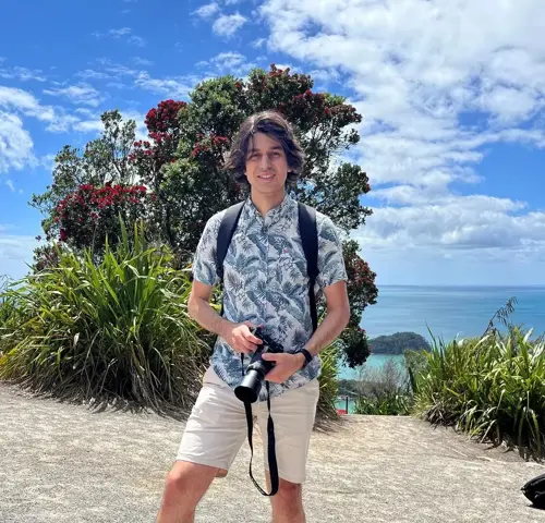 Luka Cosic with camera by beach