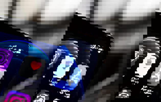 Mobile Phone Displaying Apps loading=