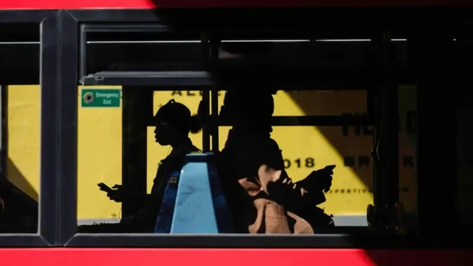 People on a bus with phones