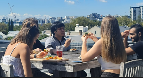 people eating lunch outside on table
